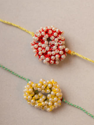 Beaded Coral Crochet Rakhi (Set Of 2)