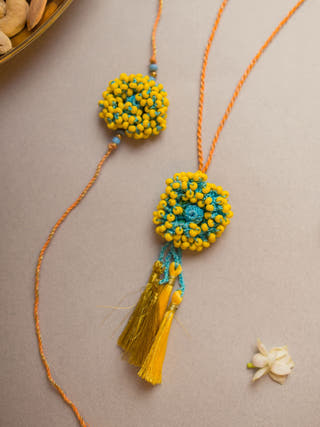 Yellow Coral Crochet Rakhi & Lumba Set (Set Of 2)