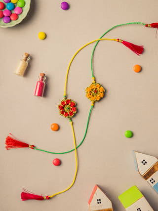 Festive Marigold Crochet Rakhi Set (Set Of 2)